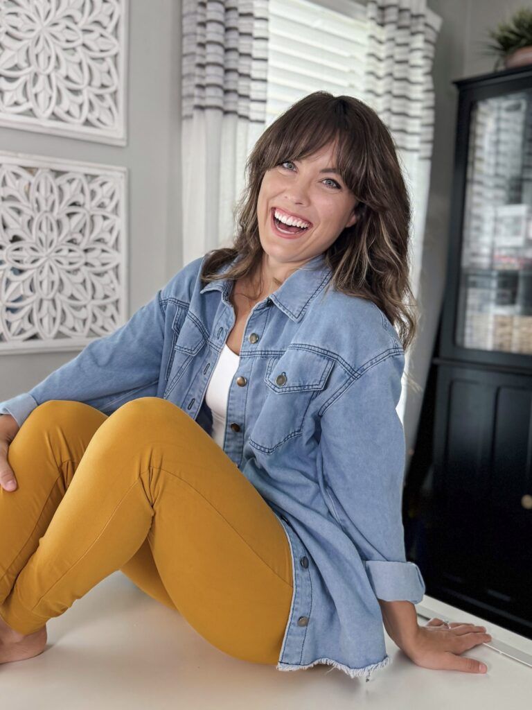 sitting on learning table blue shacket yellow pants