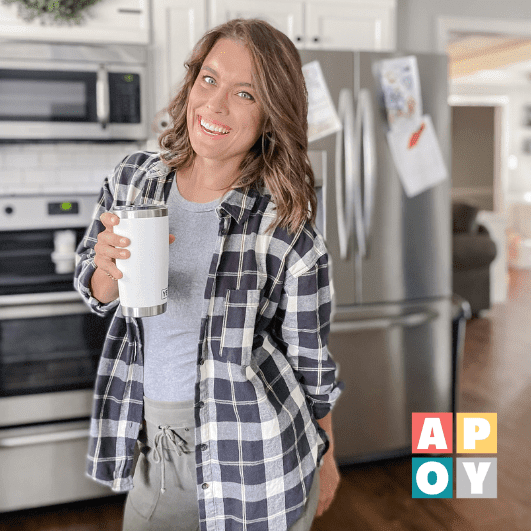 woman standing in kitchen with coffee mug